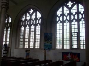 Ornate leaded glass windows down the side of the church...