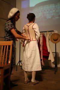 Now we get a back view as Kitty finishes the lacing.